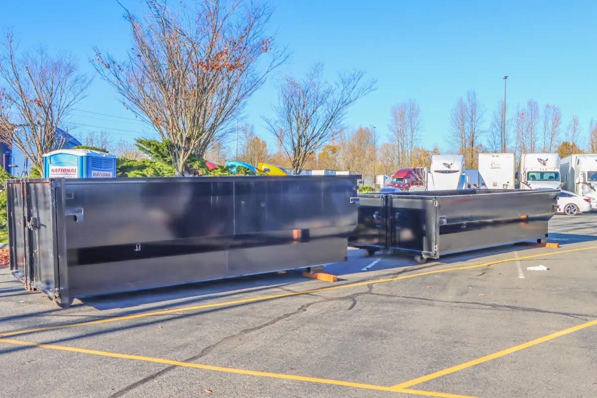 Professional dumpster rental service with roll-off container on residential driveway in Kearney